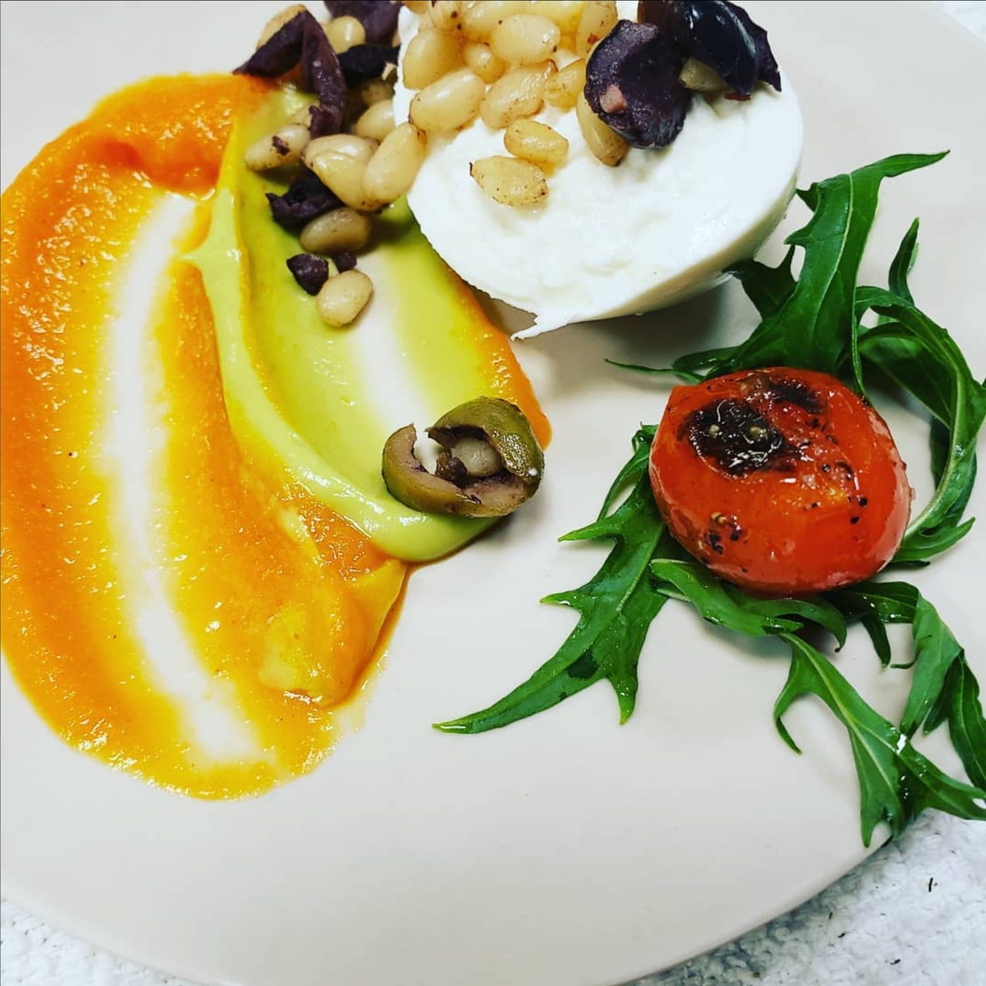 Burrata with olives, pine nuts and carrot purée